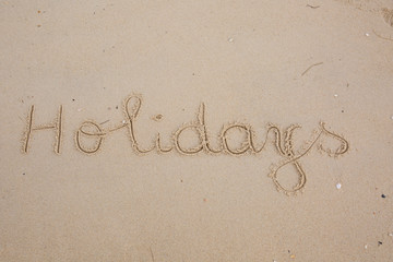 The inscription on the sand - holidays, vacation paradise.