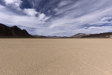 Dry lake bed in desert with cracked mud on a lake floor