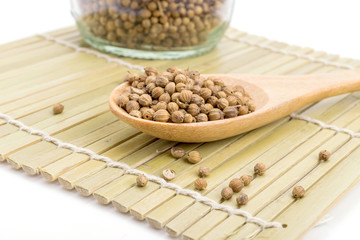 coriander seeds in a wooden spoon