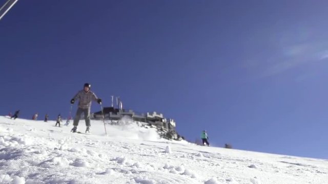 Spectacular Slow Motion Of Skier Skiing Down And Spraying Snow At Camera
