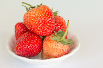 Ripe strawberries on  white cup