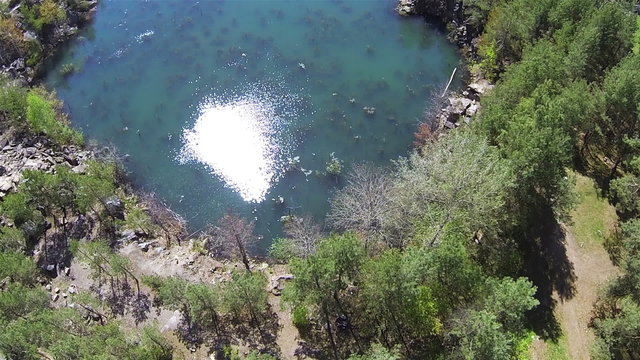 Reflection of  sun in water of  canyon lake. Aerial  POV top