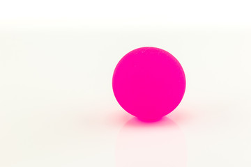 Pink rubber ball on white background