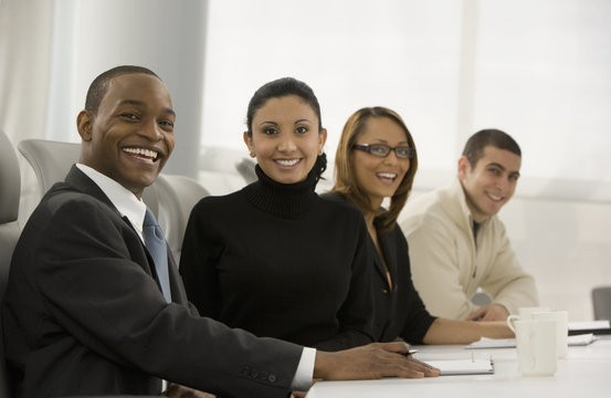 Multi-ethnic business people posing in meeting