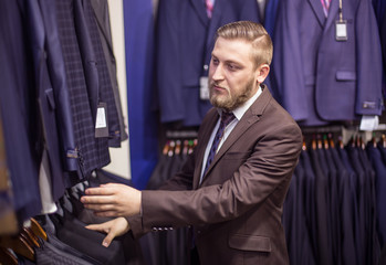 young man chooses suit