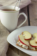 Crisp bread with cream cheese and apples and cup of tea