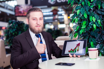 businessman holding a tablet with the schedule