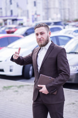 young businessman near the car