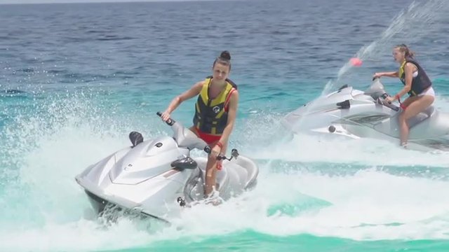 Sporty Women Friends Jet Skiing
