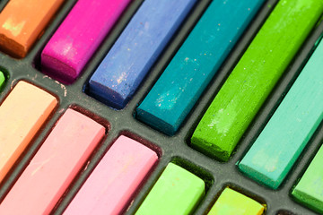 Close up Colorful chalks in a variety of colors arranged in tray