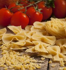 Variety of pasta on a wooden table, selective focus