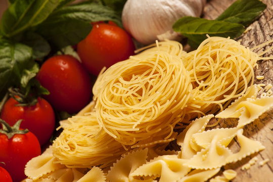 Variety of pasta on a wooden table, selective focus
