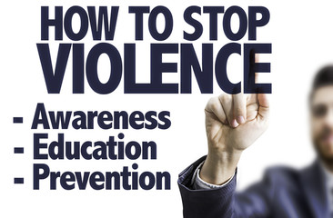 Business man pointing the text: How to Stop Violence