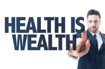 Business man pointing the text: Health is Wealth