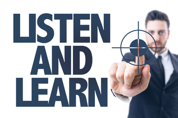 Business man pointing the text: Listen and Learn