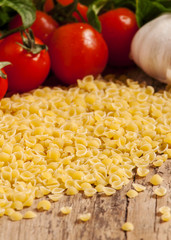 Italian dry pasta coccioline in the shape of seashells wooden ta