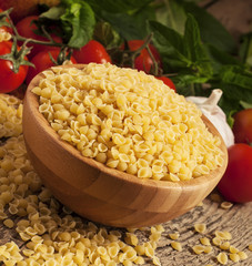 Italian dry pasta coccioline in the shape of seashells wooden ta
