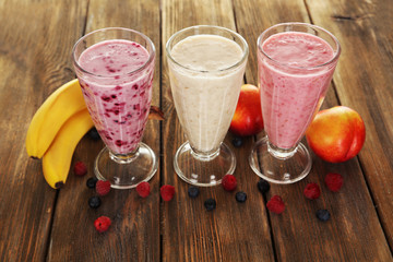 Milk cocktail with banana, blackcurrant and raspberry in a glass