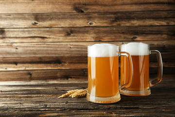 Mug of beer on a brown wooden background