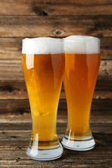 Glass of beer on a brown wooden background