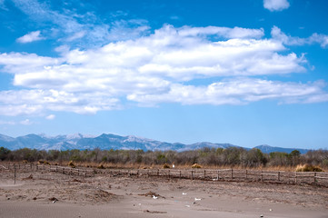 Sandy beach, mountains and blue sky.