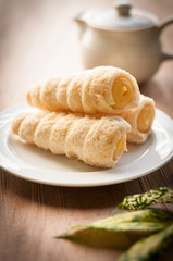 Cream-filled pastry roll on the wood board