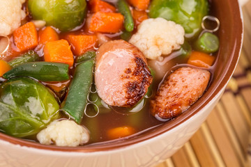 Fresh vegetable soup with sausage.