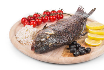 Fried carp on wooden platter.