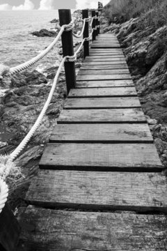 Fototapeta Wood bridge the sea black and white