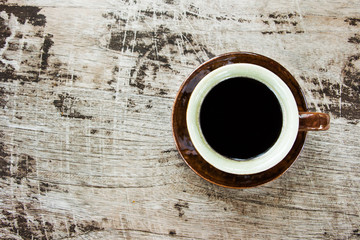 Top view of coffee cup on wood table.