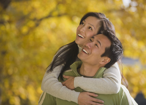 Asian woman hugging boyfriend