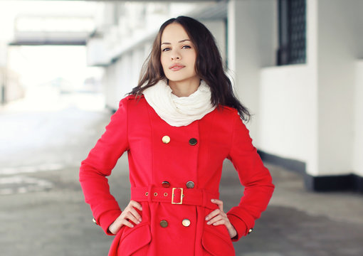 Portrait of beautiful young woman dressed a red jacket outdoors