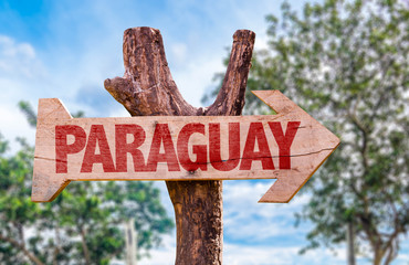 Paraguay wooden sign with countryside background