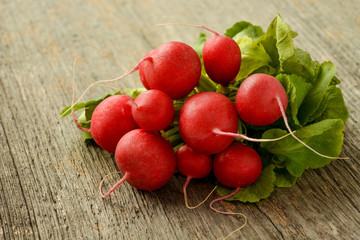Bundle of radishes on a wooden table