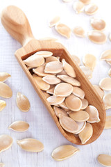 Pumpkin seeds on white wooden table