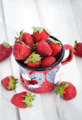 Fresh strawberries  in a tin mug
