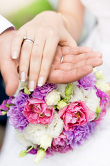 Obraz na płótnie Canvas soft focus photo of groom holding brides hand on bridal bouquet