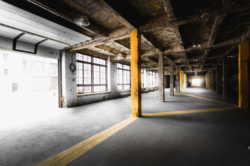 old abandoned factory hallway with big windows