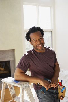 African carpenter in livingroom
