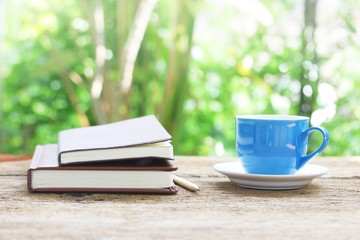 Notebook  and coffee cup on wooden table