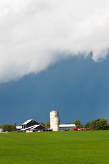 Fototapeta na wymiar Clouds settling down over farm