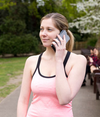 young woman on the phone in the park