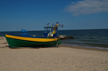 Fishing boat on the beach of Baltic Sea in Poland.