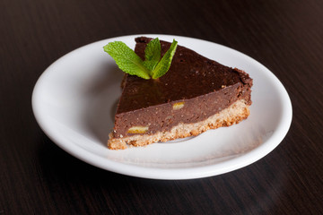 Delicious chocolate pie, with orange and a mint leaf for garnish