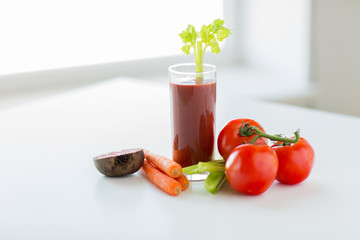 close up of fresh juice and vegetables on table