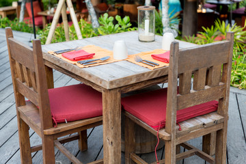 close up of cutlery with glass and napkin on table