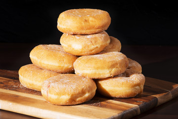 Group of fresh baked cinnamon donuts with raspberry jam. 