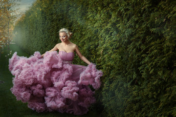Girl in a magnificent dress dances.