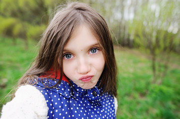 Fototapeta premium Adorable pre-teen kid girl makes selfi