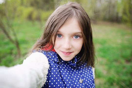 Adorable pre-teen kid girl  makes selfi
